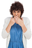 Surprised attractive woman placing hands on her mouth