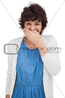 Smiling woman placing her hand on her mouth