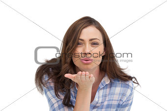 Cute woman blowing a kiss to the camera