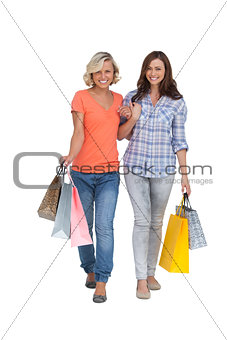 Two cheerful friends with shopping bags