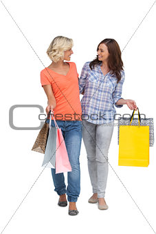 Two smiling friends with shopping bags