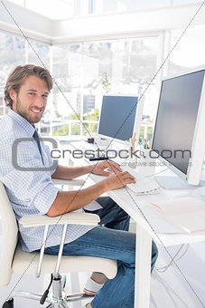 Happy designer working at his desk