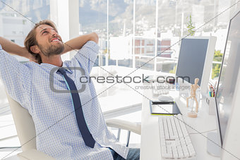 Designer leaning back at his desk