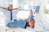 Designer relaxing at desk with no shoes