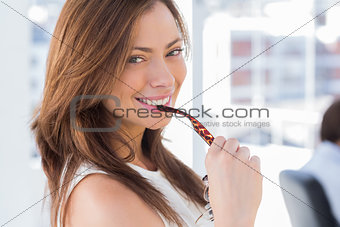 Portrait of attractive woman biting glasses