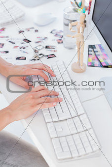 Close up of womans hands typing