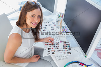 Smiling designer holding contact sheet