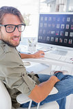 Smiling photo editor at his desk