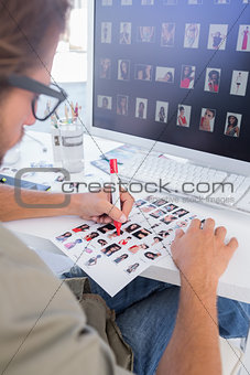 Photo editor making some cuts on the contact sheet