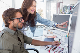 Colleague pointing photo out to editor