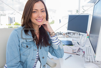 Attractive designer smiling in creative office
