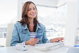Attractive woman purchasing online with her credit card