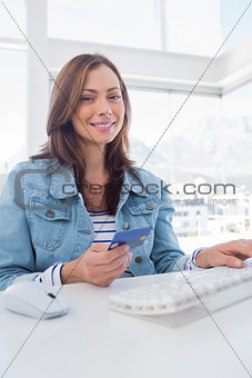 Pretty woman purchasing online with her credit card