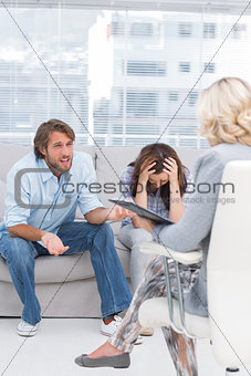 Therapist listening to the couple sit on the couch