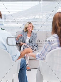 Smiling therapist speaking a couple