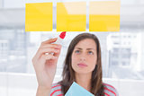 Woman writing on sticky note