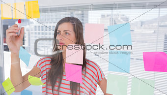 Young woman writing in creative office