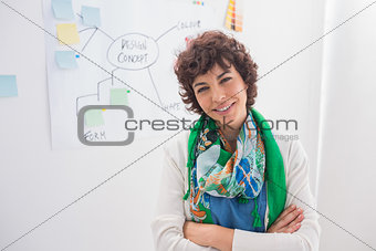 Smiling designer with arms folded