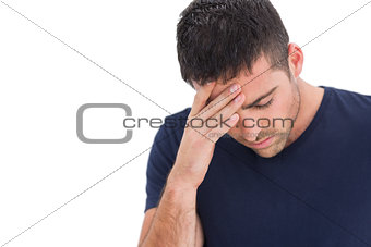 Upset man standing with his hand holding his forehead
