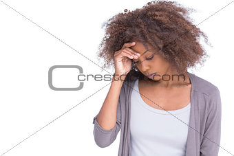 Sad woman holding her forehead with her hand