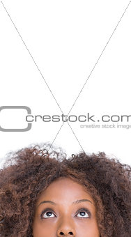 Brunette woman looking up to large copy space