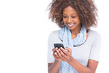 Cheerful woman typing a text message on her smartphone