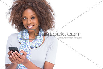 Cheerful woman typing a text message