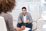 Depressed man speaking to a therapist
