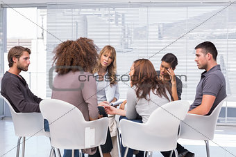 Patients around therapist in group therapy session