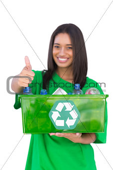 Enivromental activist holding box of recyclables and giving thumbs up
