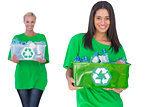 Two enivromental activists holding box of recyclables