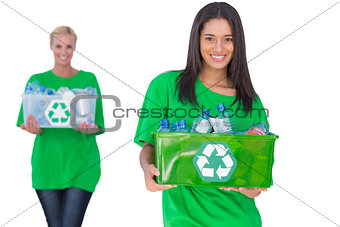 Two enivromental activists holding box of recyclables