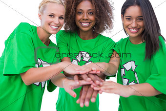 Three happy enviromental activists putting their hands together