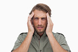 Man grimacing with pain of headache