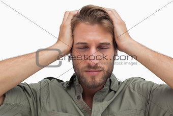Exhausted man with hands on head
