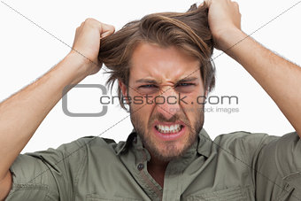 Furious man pulling his hair