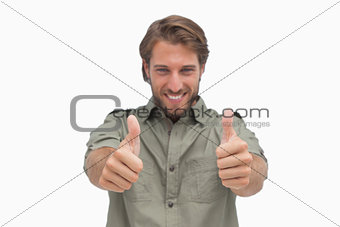 Happy man giving thumbs up to camera