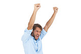 Smiling man celebrating success with arms up