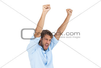 Smiling man celebrating success with arms up