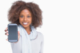 Woman with afro showing her smartphone