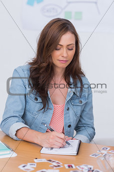 Editor taking notes during meeting