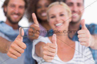 Happy fashionable group giving thumbs up