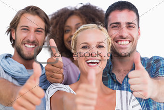 Happy group giving thumbs up