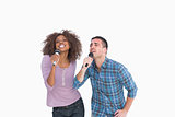 Fun duo singing at karaoke