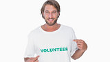 Man pointing to his volunteer tshirt