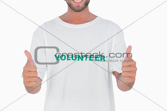 Man wearing volunteer tshirt giving thumbs up