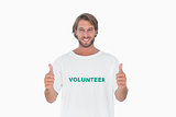 Happy man wearing volunteer tshirt giving thumbs up