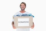 Happy man carrying donation box