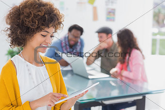 Editor using tablet and smiling