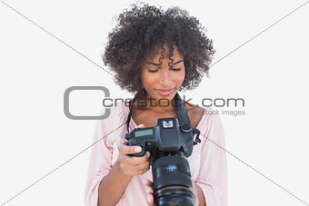 Happy woman looking at digital camera